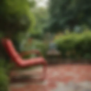 Close-up of a bright red patio chair against a lush garden background