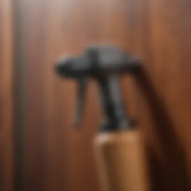 Close-up of stain sprayer and wooden texture