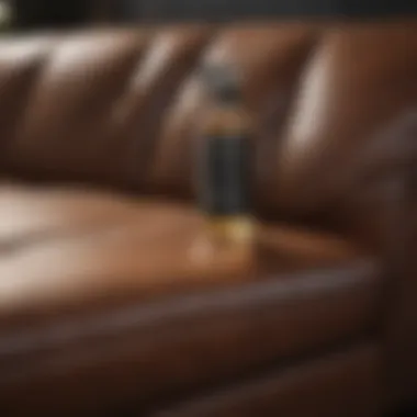 DIY leather cleaning solution being applied to a couch