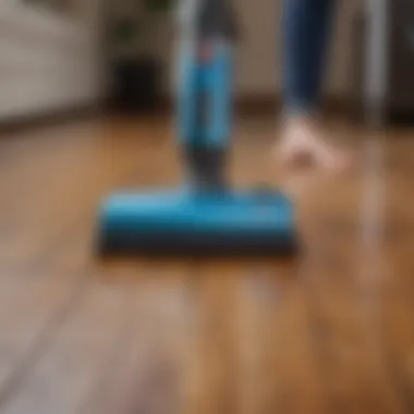 An individual using a vacuum cleaner on hardwood floors
