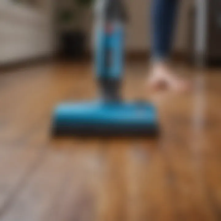 An individual using a vacuum cleaner on hardwood floors