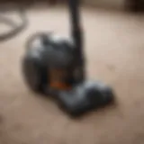 Traditional manual vacuum cleaner in action on a carpet