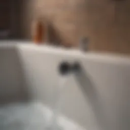 A close-up view of a bathtub drain with standing water