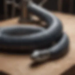 A close-up view of a plumbing snake coiled elegantly on a workbench